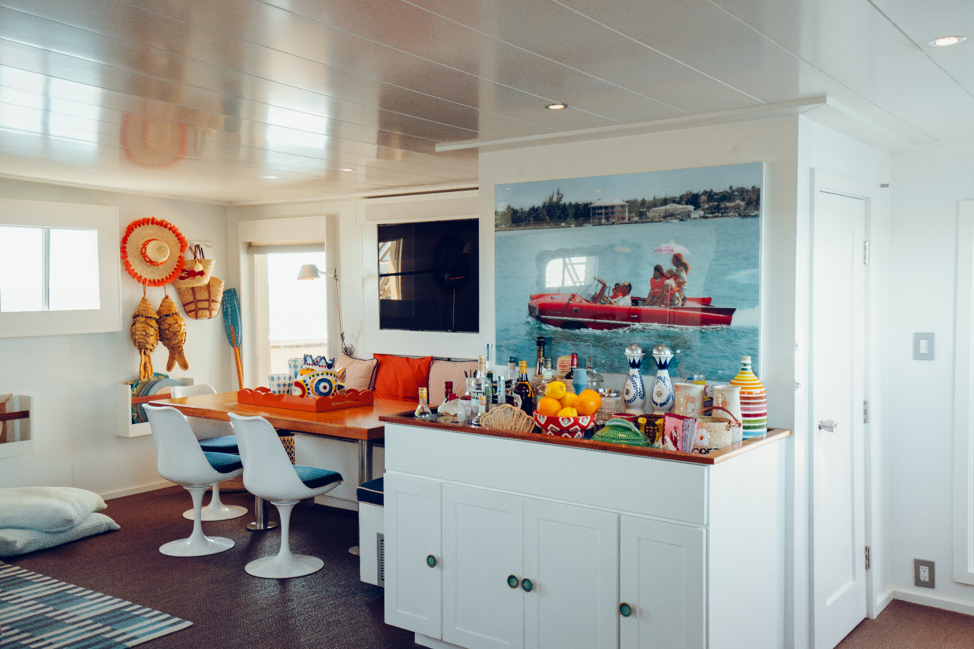 Main salon bar and dining nook with Slim Aarons artwork