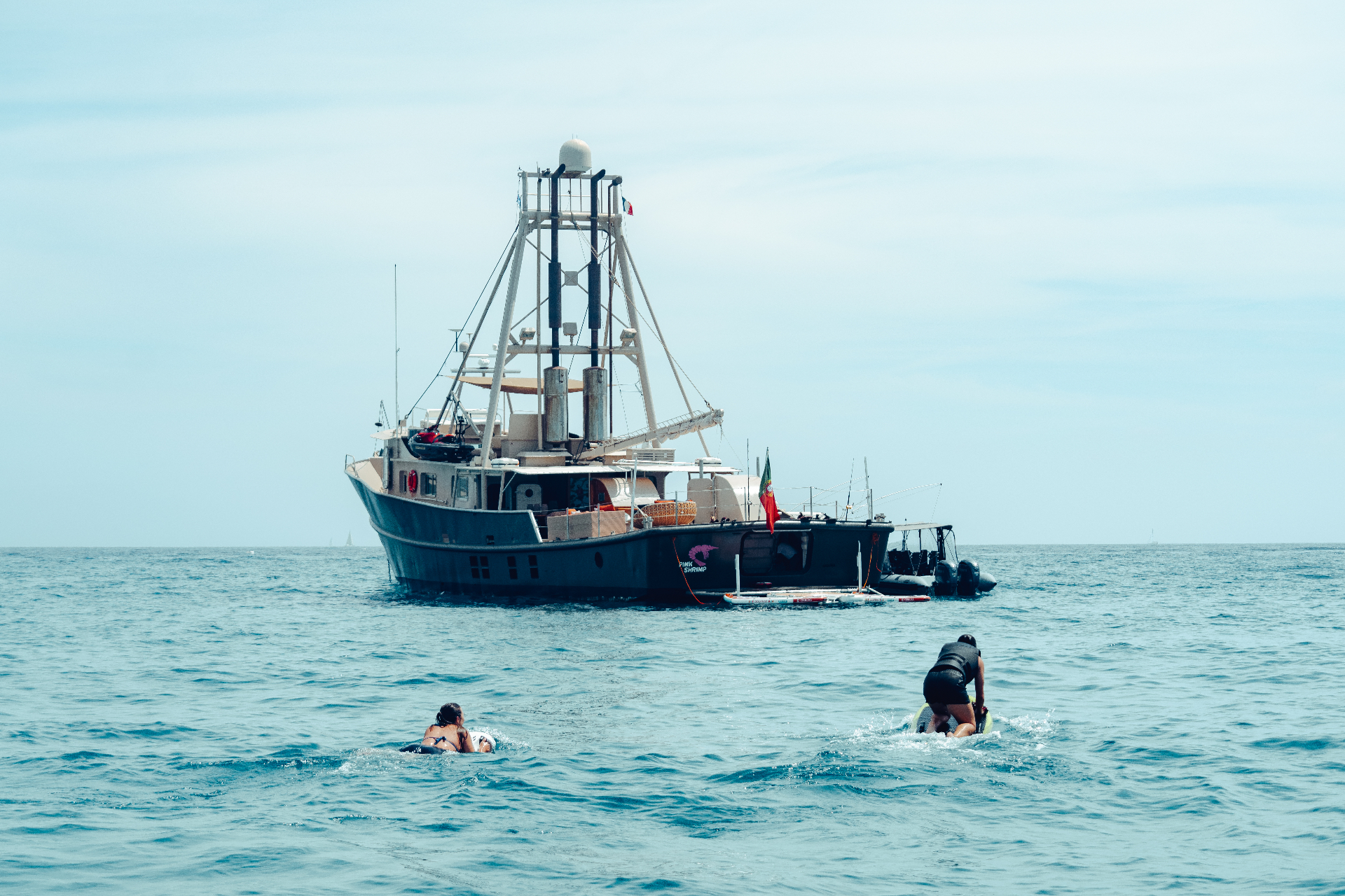 Guests swimming and playing off Pink Shrimp at anchor